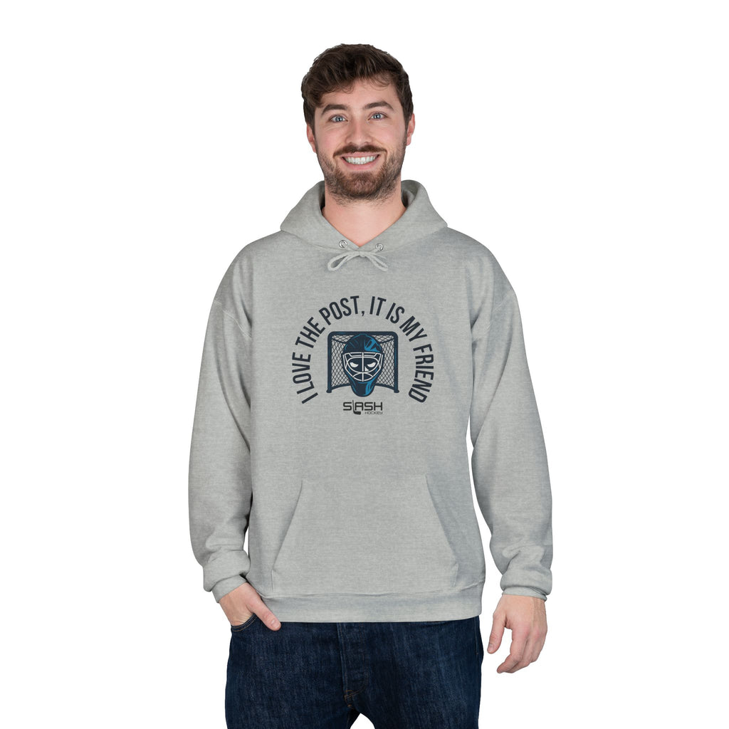 Male model wearing goalie hoodie with “I love the post, it is my friend” design, standing in casual hockey-inspired setting.