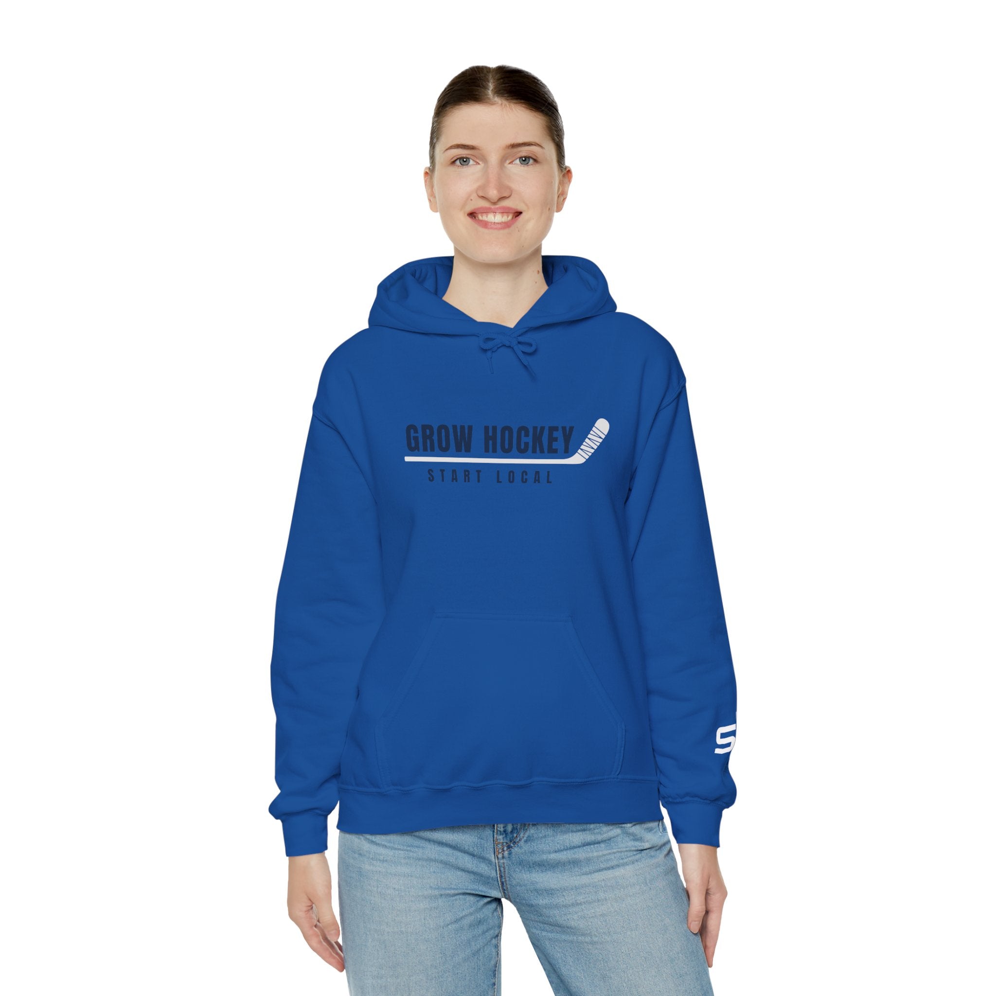 Female model wearing Grow Hockey Start Local hoodie featuring bold hockey typography and taped stick graphic.