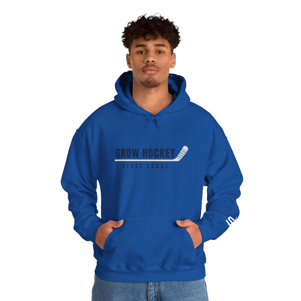 Male model wearing Grow Hockey Start Local hoodie with bold front graphic and taped hockey stick design.