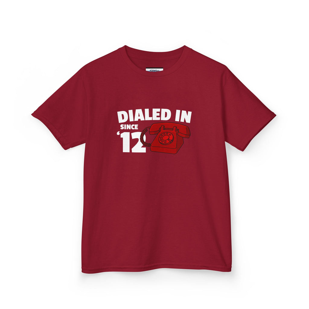 Youth Dialed In Since ’12 Tee, front view — youth hockey t-shirt featuring a bold “Dialed In Since ’12” graphic on the chest, clean athletic fit, displayed on a plain background.