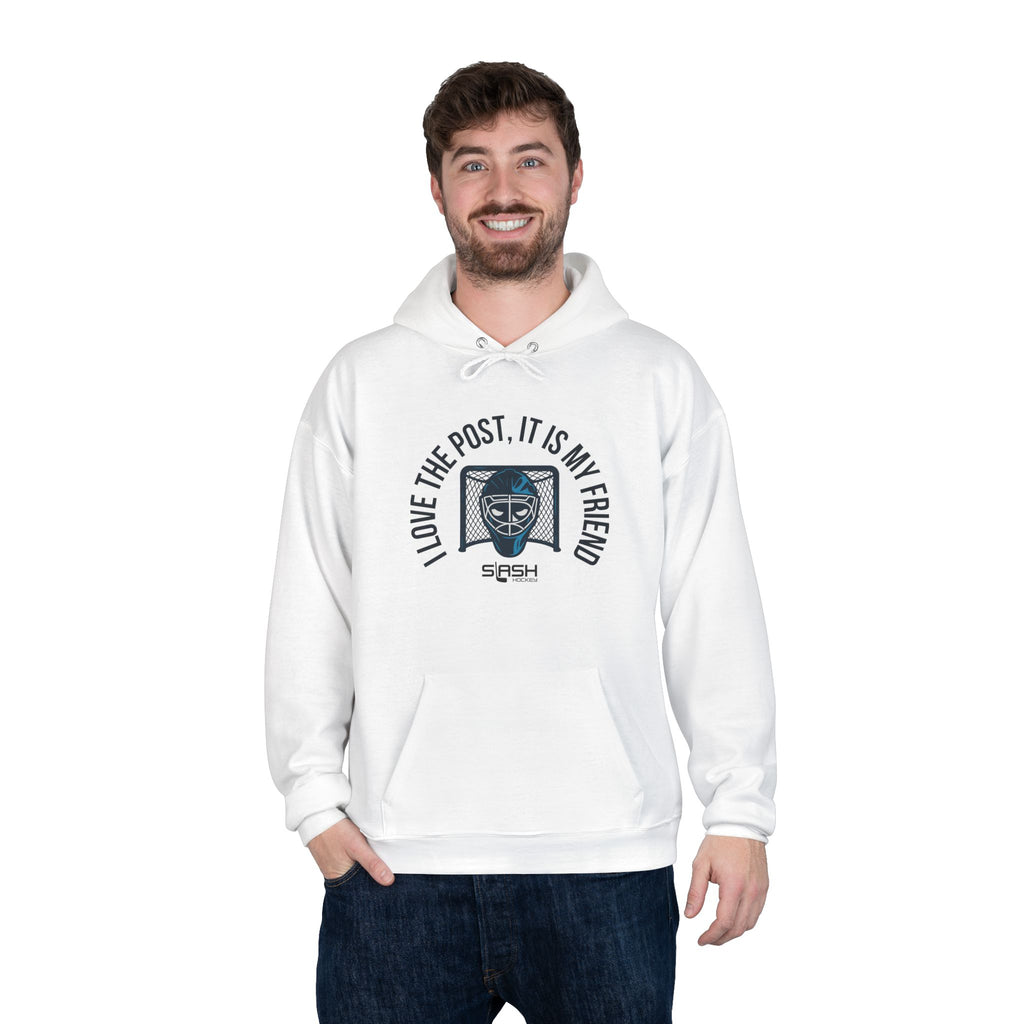 Male model wearing goalie hoodie with “I love the post, it is my friend” design, standing in casual hockey-inspired setting.