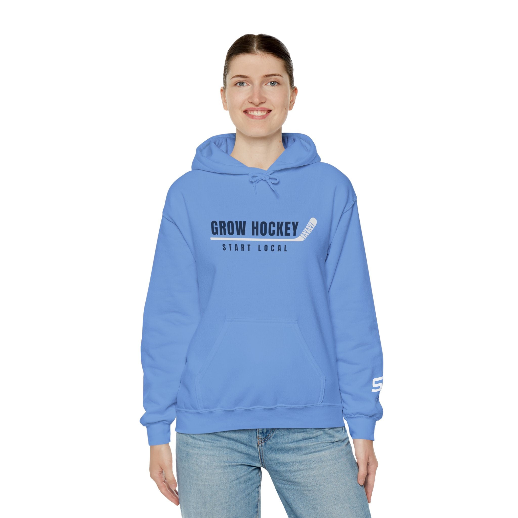 Female model wearing Grow Hockey Start Local hoodie featuring bold hockey typography and taped stick graphic.