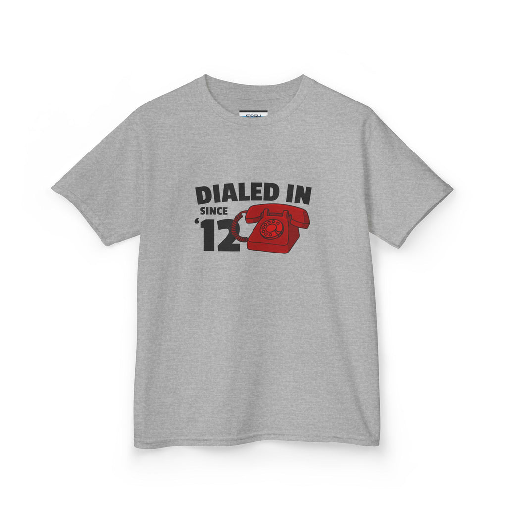 Youth Dialed In Since ’12 Tee, front view — youth hockey t-shirt featuring a bold “Dialed In Since ’12” graphic on the chest, clean athletic fit, displayed on a plain background.