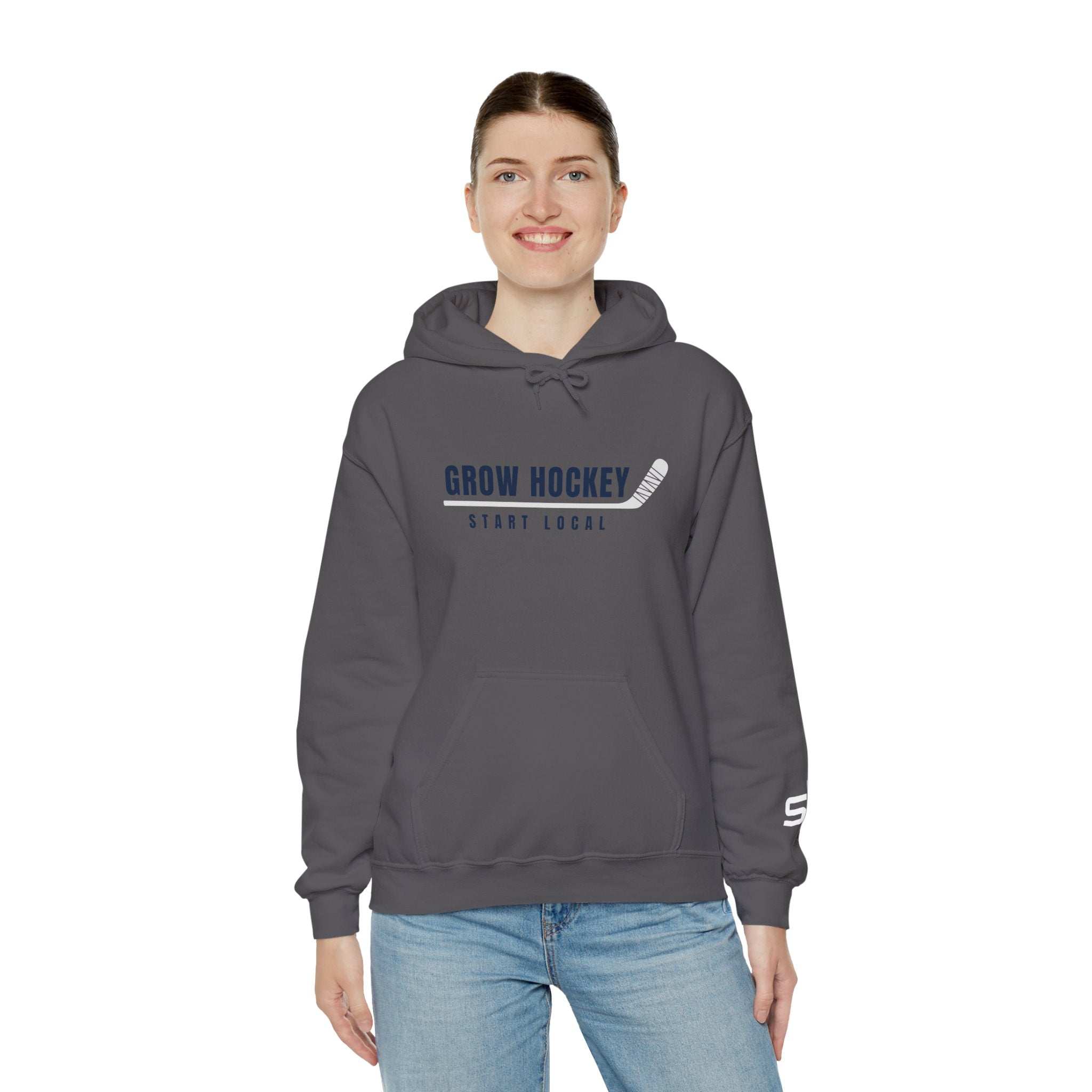 Female model wearing Grow Hockey Start Local hoodie featuring bold hockey typography and taped stick graphic.
