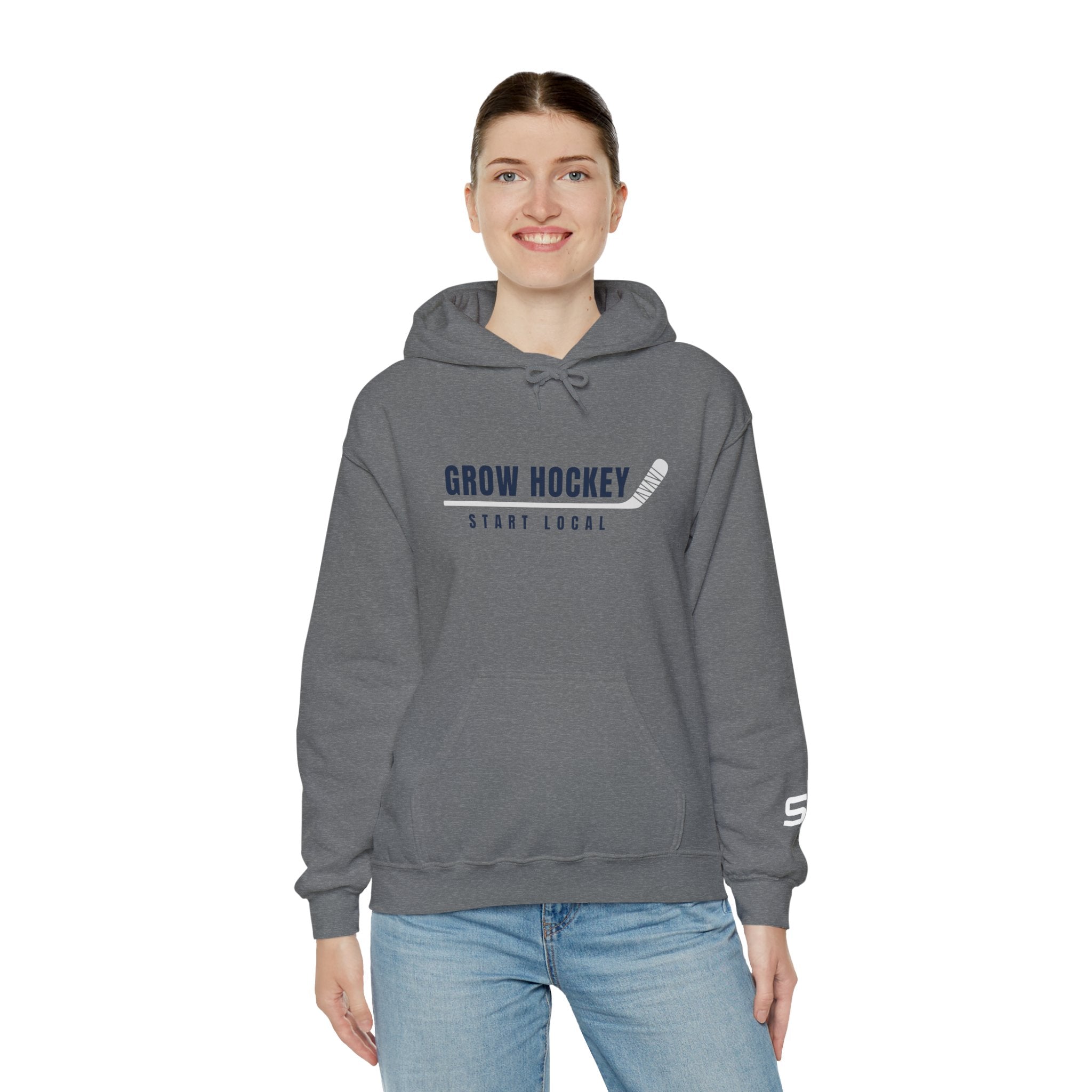 Female model wearing Grow Hockey Start Local hoodie featuring bold hockey typography and taped stick graphic.