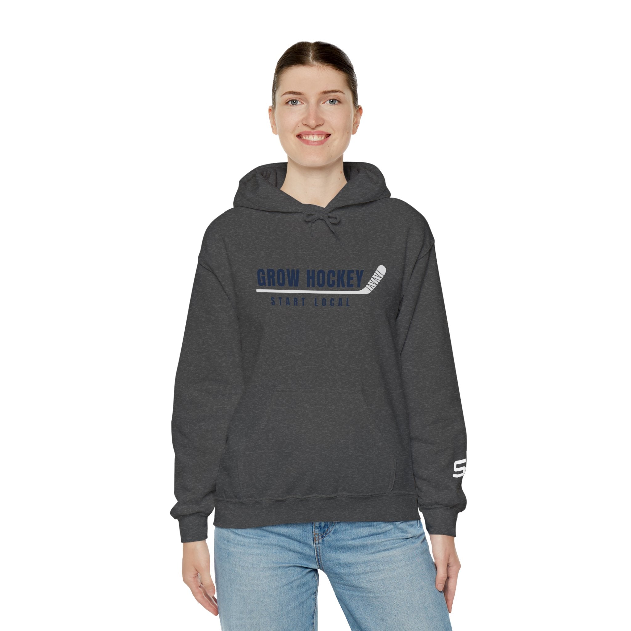 Female model wearing Grow Hockey Start Local hoodie featuring bold hockey typography and taped stick graphic.