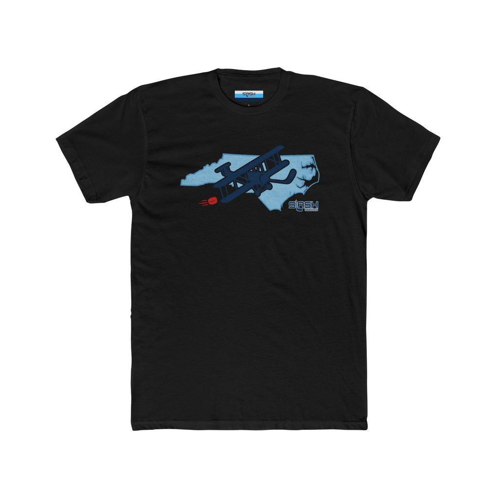 Front view of black t-shirt featuring North Carolina outline with ice texture. Wright Brothers airplane with hockey stick wings flies across, trailing a red puck.
