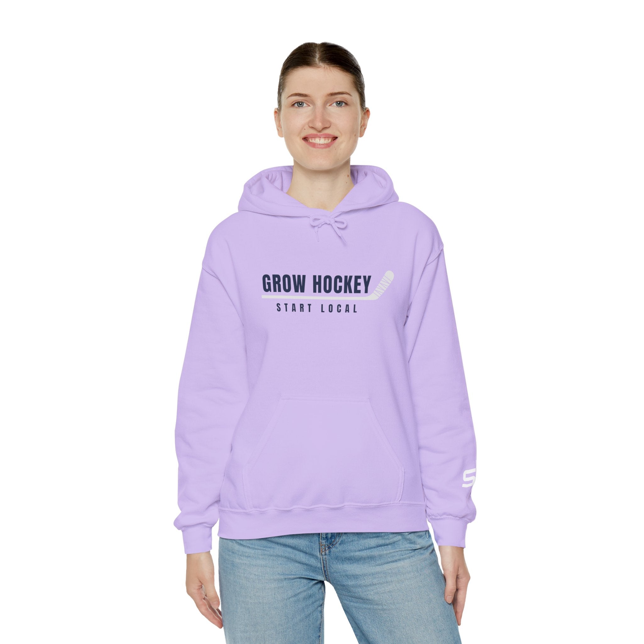 Female model wearing Grow Hockey Start Local hoodie featuring bold hockey typography and taped stick graphic.