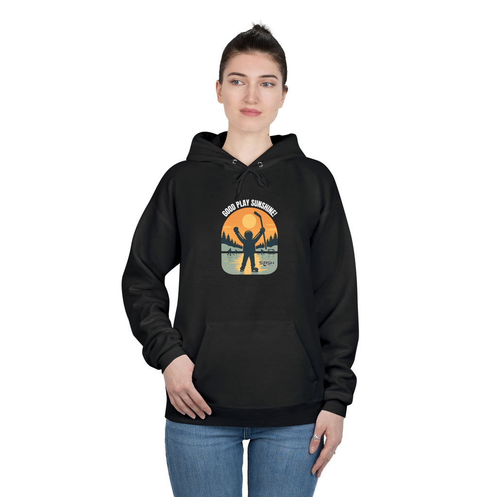Female model wearing the Good Play Sunshine! Hoodie by Slash Hockey, styled casually for everyday comfort, featuring the retro pond hockey sunrise design.